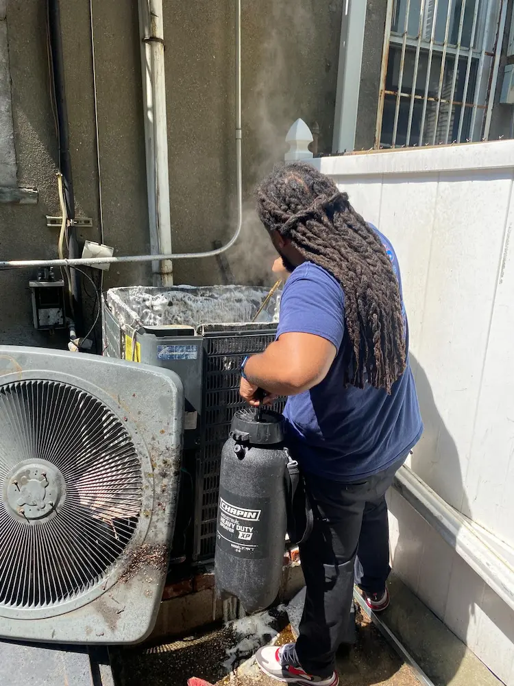 miller-hvac-tech-working-on-ac (2) Miller HVAC technician repairing AC unit