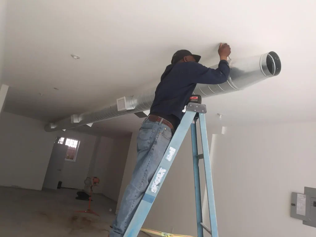tech-working-on-commercial-refrigeration-unit Technician working on commercial HVAC unit